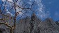 Grey karst limestone cliffs against a blue sky background. Royalty Free Stock Photo