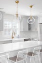 A grey kitchen with gold lights and faucet.