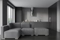 Grey kitchen interior with couch and cooking space with panoramic window Royalty Free Stock Photo