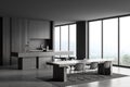 Grey kitchen interior with table and seats, dining area and panoramic window Royalty Free Stock Photo