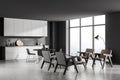 Grey kitchen with seating space, round dining table and panoramic view Royalty Free Stock Photo