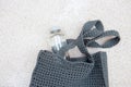 Grey knitted bag handmade and a bottle of water outdoors. Sustainable shopping. Waste-free lifestyle Royalty Free Stock Photo