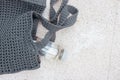 Grey knitted bag handmade and a bottle of water outdoors. Sustainable shopping. Waste-free lifestyle Royalty Free Stock Photo