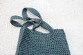 Grey knitted bag handmade outdoors. Sustainable shopping. Waste-free lifestyle Royalty Free Stock Photo