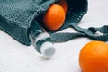 Grey knitted bag handmade, ripe oranges and a bottle of water outdoors. Sustainable shopping. Waste-free lifestyle Royalty Free Stock Photo