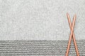 Grey knitted fabric made of heathered yarn with knitting forks b Royalty Free Stock Photo