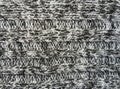 Grey knitted fabric texture as background. Beautiful pattern.