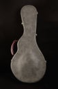 Grey leather case for mandolin on black background. Royalty Free Stock Photo