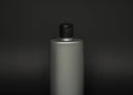 Grey liquid container for gel, lotion, cream, shampoo, bath foam. Cosmetic plastic bottle on black background. Cosmetic Royalty Free Stock Photo