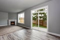 Grey living room interior. Windows and Glass doors overlooking the back yard.