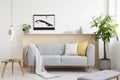 Grey lounge with cushions and blanket standing in real photo of Royalty Free Stock Photo