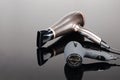 Grey mat and bown hair dryer on the grey mirror background Royalty Free Stock Photo