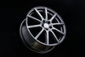 Grey Matt caluminum alloy wheel disc on black background. Sports a lot of spokes