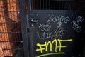 Grey Metal Fence Gate See-Through Chalk Orange White Stone Brick Blurry Pipe Background