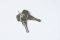 Grey metal keys on white background. Keys for the door lock. Two keys to the front door. Royalty Free Stock Photo