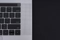 Grey metal laptop on black background close up. View from above on keyboard. Royalty Free Stock Photo