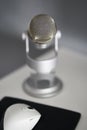 Grey microphone in a white table