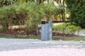 grey minimalist garbage can with mulched landscape in the park