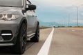 Grey modern car parked on asphalt road Royalty Free Stock Photo