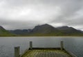 Icelandic mountains in clouds from a pier