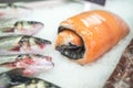 Grey mullet next to salmon rolled up in cellophane on crushed ice,displayed at Kotor market,Kotor,Montenegro Royalty Free Stock Photo