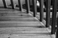 Grey newel posts on wooden landing in black and white.