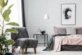 Grey patterned armchair in bedroom