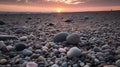 grey pebbles on beach at sunset with pink glow grom sunset on some of the pebbles