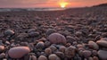 grey pebbles on beach at sunset with pink glow grom sunset on some of the pebbles