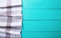 Grey plaid tablecloth on blue rustic wooden kitchen workspace, top view and copy space. Mock up and wood background. Royalty Free Stock Photo