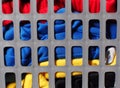 Grey plastic laundry basket full with dirty colorful clothes Royalty Free Stock Photo