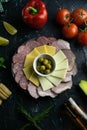 Grey plate with olives around the salami, ham, cheese and mozzarella. Tomato, souce, olives, lemon, olive oil with spice Royalty Free Stock Photo