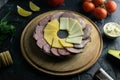 Grey plate with salami, ham, cheese and mozzarella. Around tomato, souce, olives, lemon, olive oil with spice Royalty Free Stock Photo