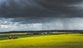 Grey rainy sky above the green meadow. Ireland.