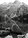 A grey reflection of the stones of Morskie Oko - Poland - Tatra National Park in the Rybi Potok Valley Royalty Free Stock Photo