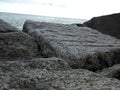 grey rocks ocean beach water Royalty Free Stock Photo
