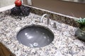Grey round sink with granite counter. Royalty Free Stock Photo