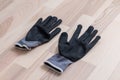 Grey rubberized work gloves on wooden surface