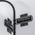 Grey scale low angle shot of street signs captured in Dusseldorf, Germany Royalty Free Stock Photo