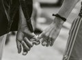Grey scale shot of a couple holding hands - concept of love and affection