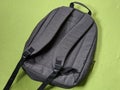 Grey school bag on green background