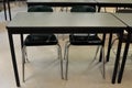 A School Desk with Two Empty Chairs