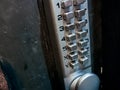 Grey silver number keypads security door locker on black door Royalty Free Stock Photo