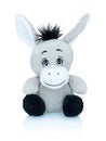 Grey smiling donkey plushie toy isolated on white background with shadow reflection. African wild plaything.