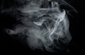 Grey smoke. Cigarette smoke on a black background. Royalty Free Stock Photo