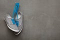 Grey sneakers with blue laces Royalty Free Stock Photo