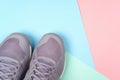 Grey sneakers on pastel background