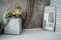 Grey sofa with chest of drawers against a gray wall