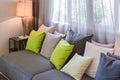 Grey sofa with green pillows in living room
