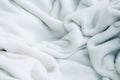 Grey soft, fluffy, light blanket. White cotton towel background